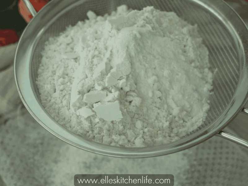 Sifting cake flour, baking soda, and salt together in a bowl