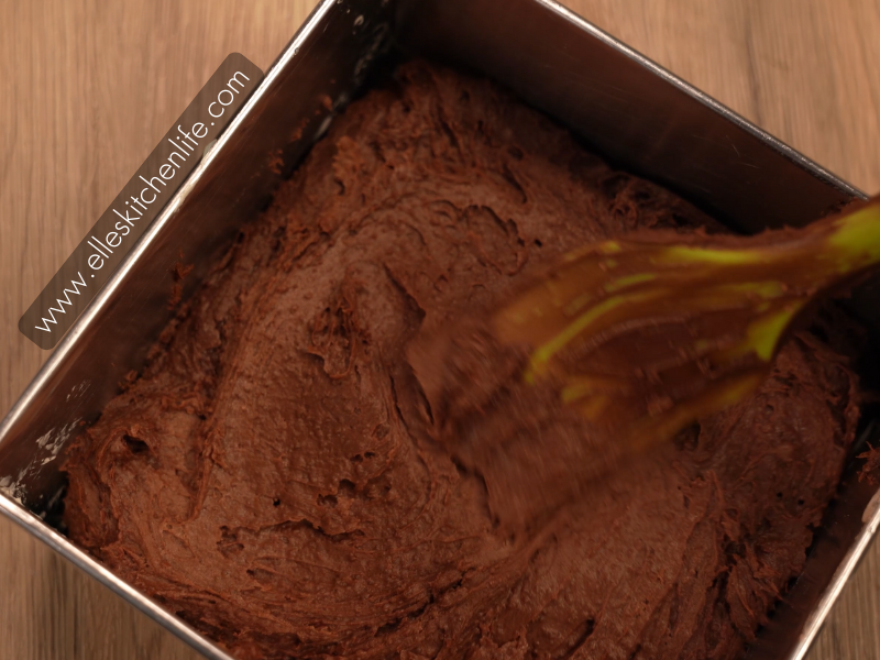 Brownie batter evenly spread in a baking pan, ready to go into the oven