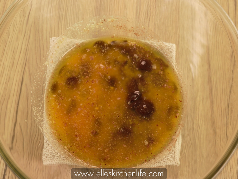 Smoothly melted chocolate and butter mixture in a bowl for brownie preparation