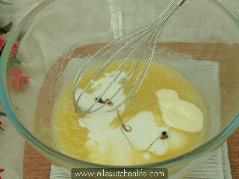 Adding sour cream, buttermilk, and vanilla extract to the mixture