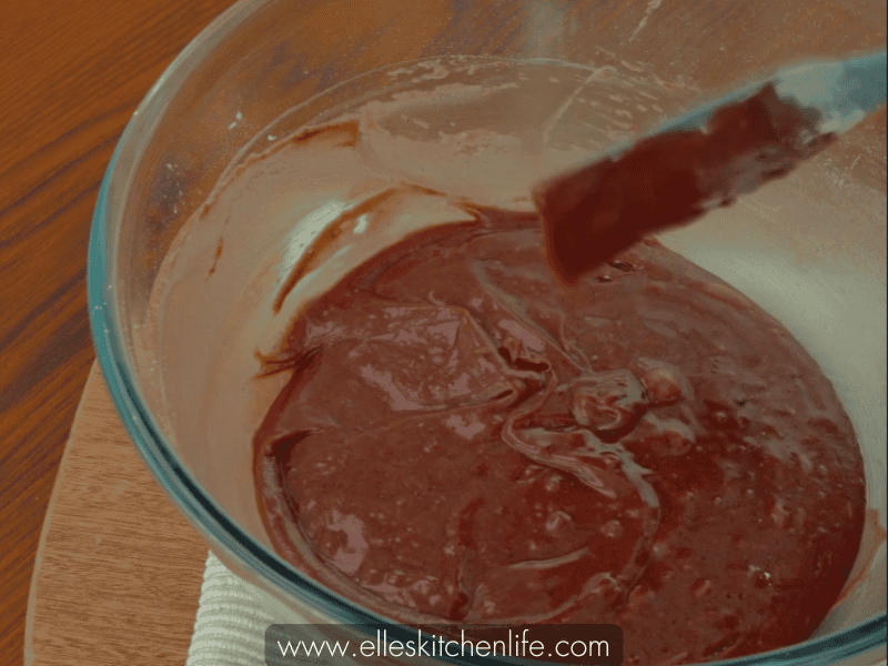 Gently folding the batter to maintain consistency