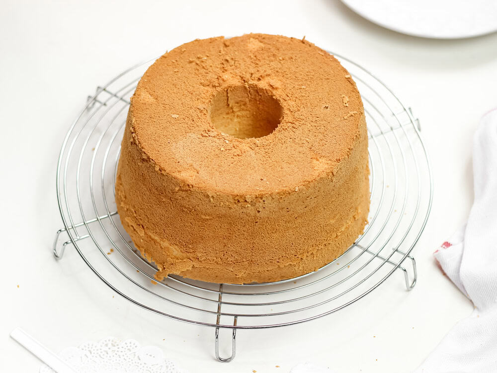 A chiffon cake cooling on a wire rack, essential for proper texture.