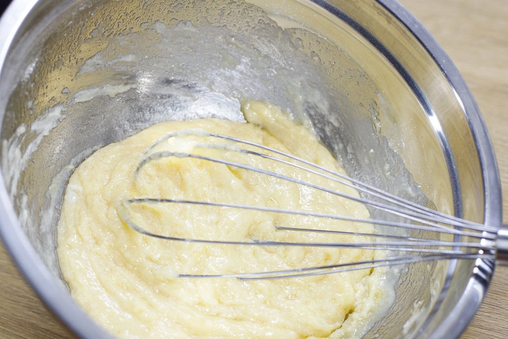 A bowl of overmixed cake batter, which can lead to a dense texture.