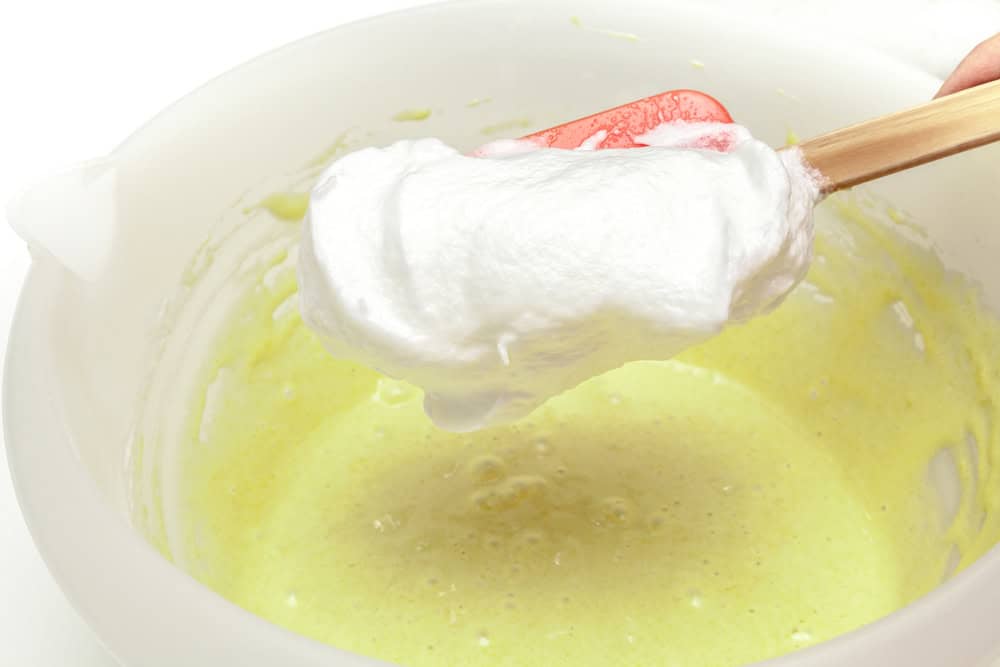 A baker rushing through a recipe with flour scattered on the counter.